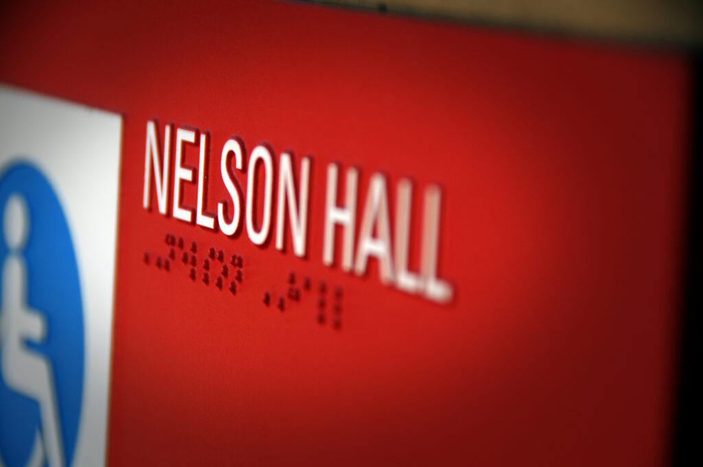 Nelson Hall Braille sign indicating accessible entrance