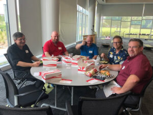 OIT staffers eat together at the welcome back to campus event.