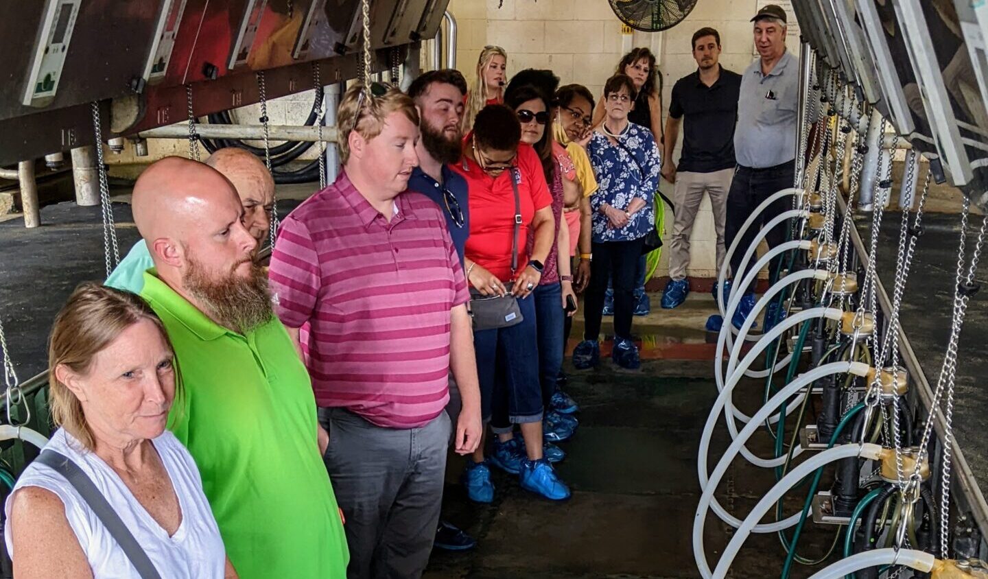 OIT staff members learn about the facility equipment at the Howling Cow Tour.