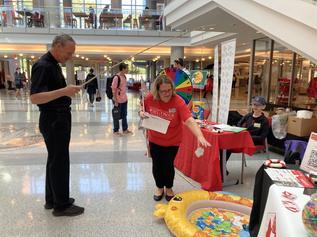 Security professional Elizabeth Cole-Walker of OIT Security and Compliance helps a participant catch a phish during "Earn Your Cyber Creds" at Talley Student Union. This event was part of Cybersecurity Awareness Month.