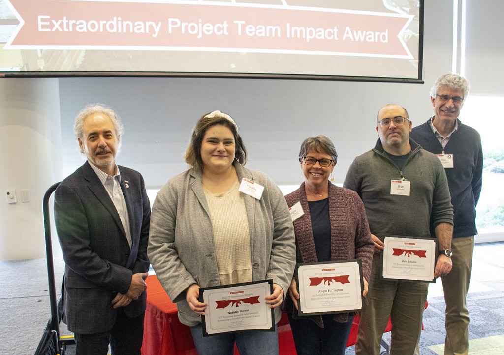 NC State CIO Marc Hoit, left, and IT Community Event Coordinator Stan Martin, right, congratulate the Research Administration (ERA) Team, which includes Natalie Boone. Angie Fullington and Matt Schultz.