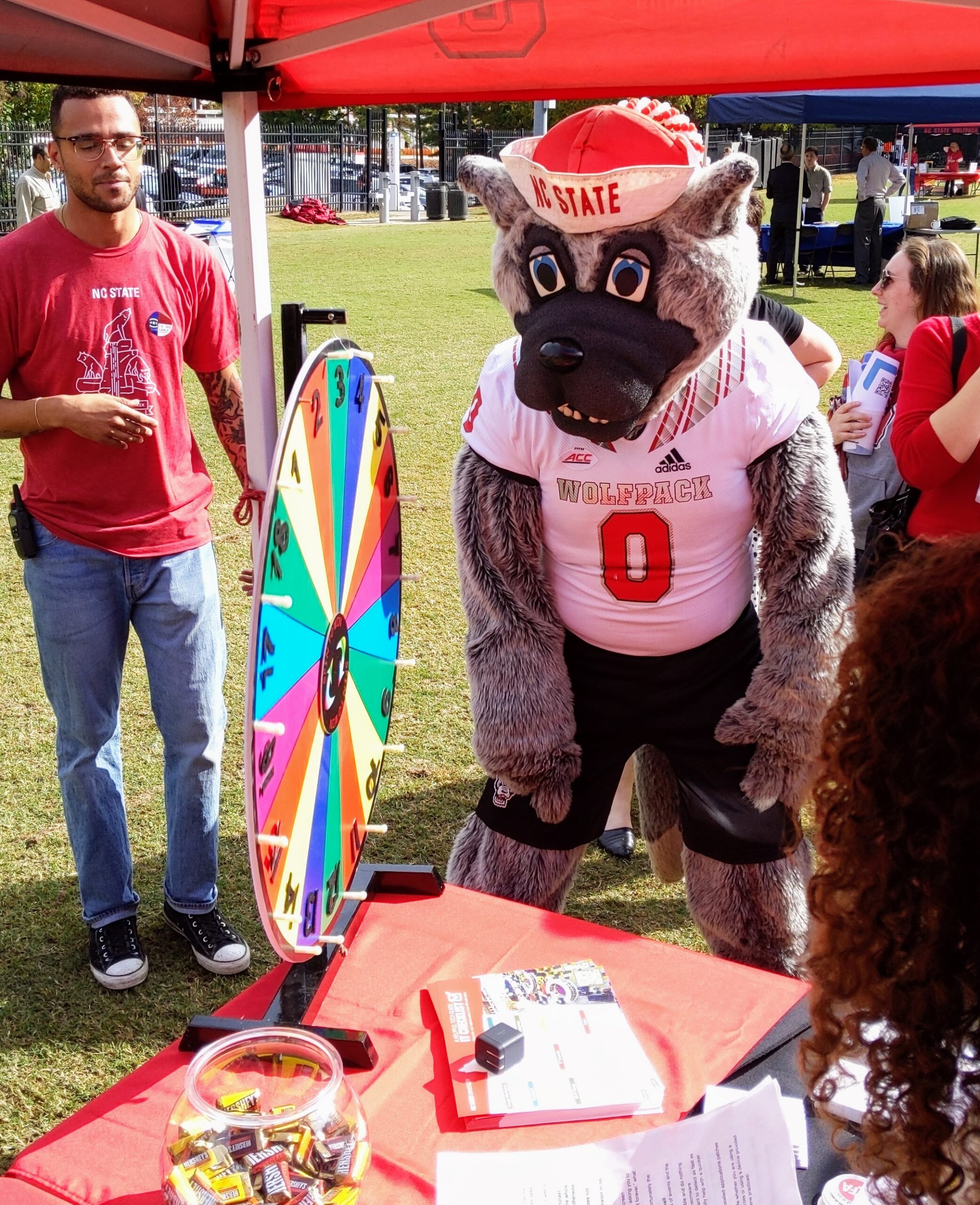 Mr. Wuf spins the wheel at OIT's table during Employee Appreciation Day.