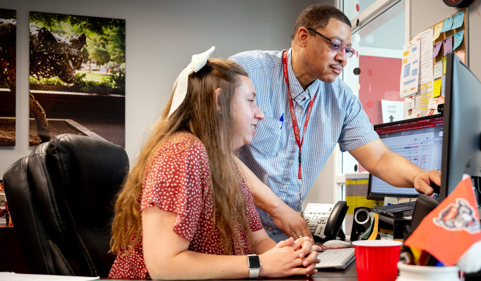 OIT employee James Glover helps a campus IT user to resolve a computing issue. 