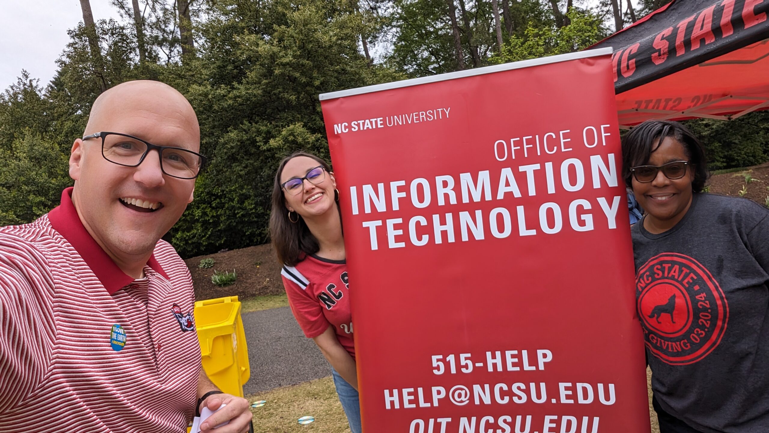 From left, Chris Shearer, Chelsea Sutton and Rhonda Greene stop for a photo at the OIT tabling event during the NC State Earth Fair.