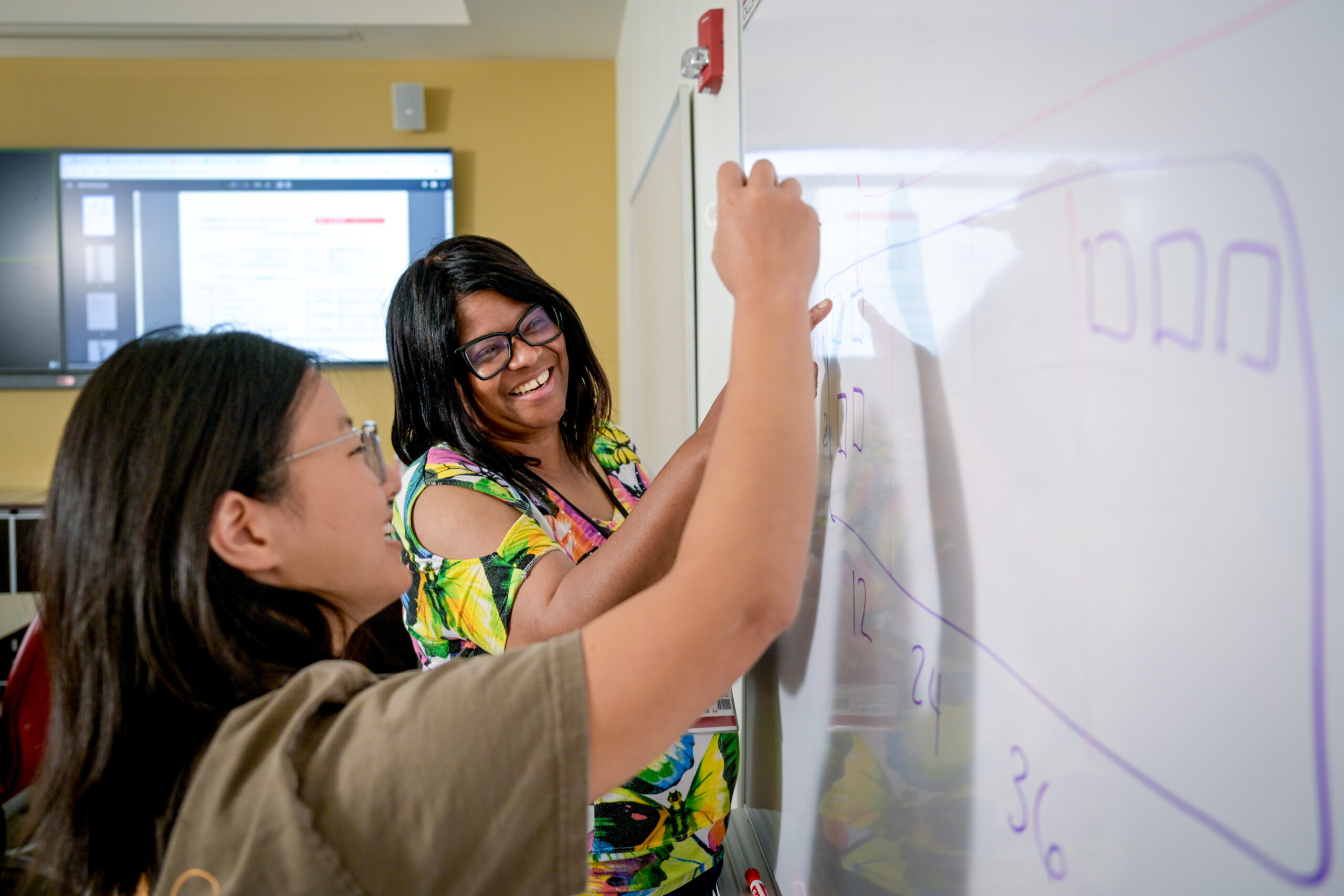 Trish Palmer, right, discusses network operations with Project Management Lite Intern Joy Nam.