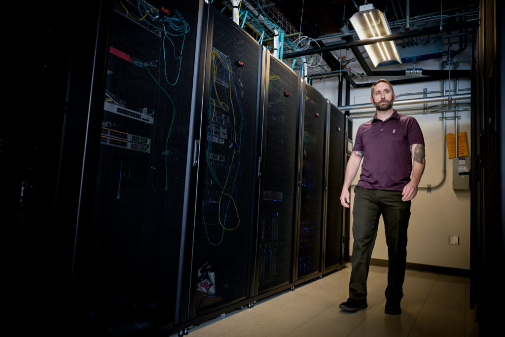 Joseph Perry walks through an OIT infrastructure lab.