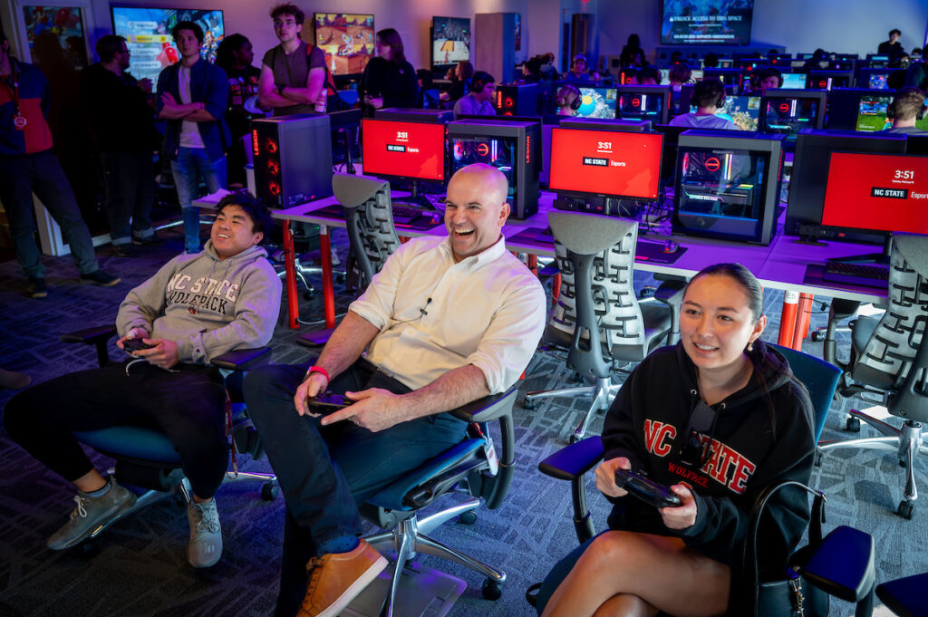 Students test their gaming expertise against College of Engineering Dean Jim Pfaendtner (center) in the new NC State Gaming and Esports Lab at Hunt Library during its 2024 open house. Photo by Becky Kirkland.