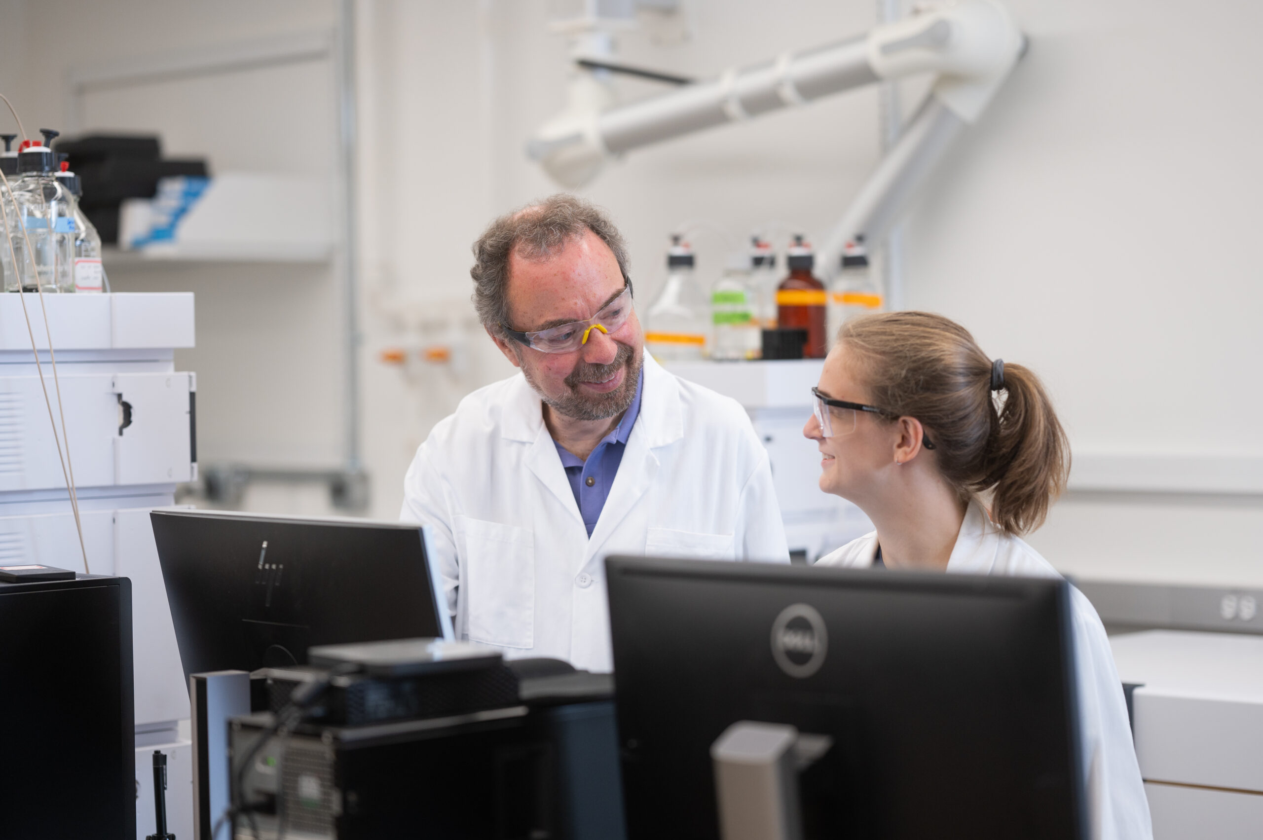 Detlef Knappe, a professor in the Department of Civil, Construction and Environmental Engineering, works with a student in his lab on Centennial Campus. Photo by University Communications.